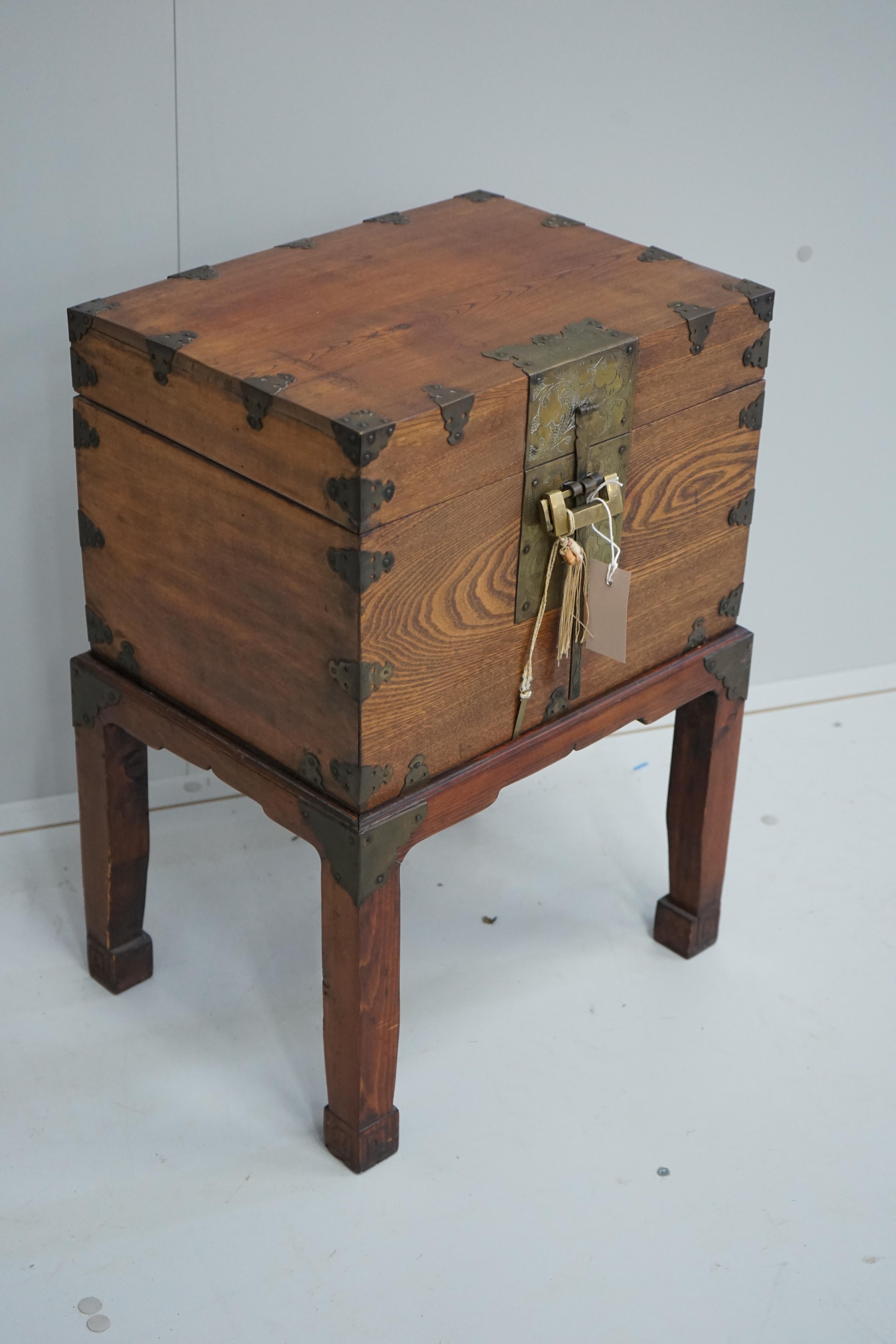 A Chinese brass mounted elm box on stand, width 42cm, depth 31cm, height 59cm